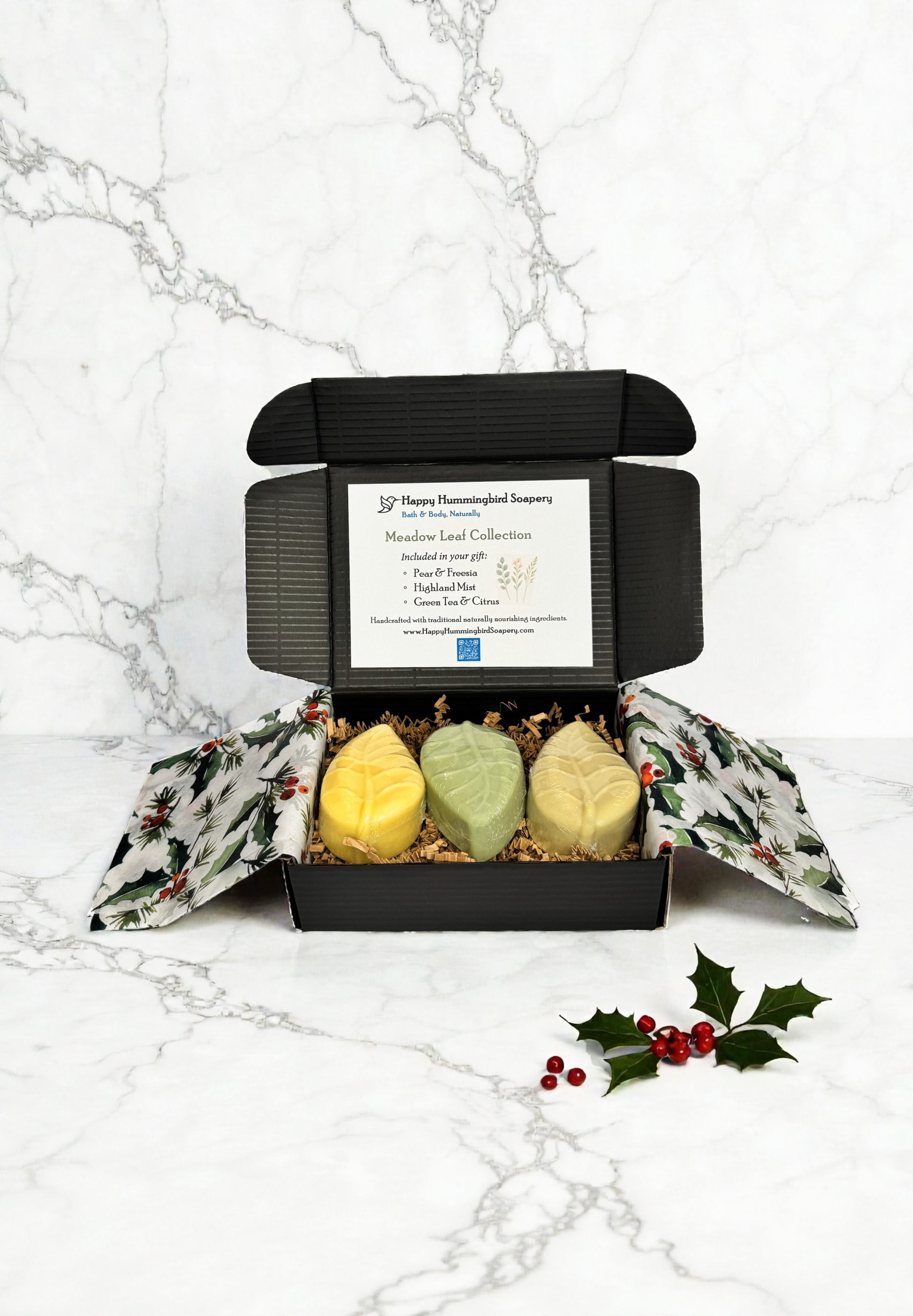 Meadow Leaf Collection open gift box with three leaf soaps, holiday tissue, crinkle fill, and collection card — Happy Hummingbird Soapery.