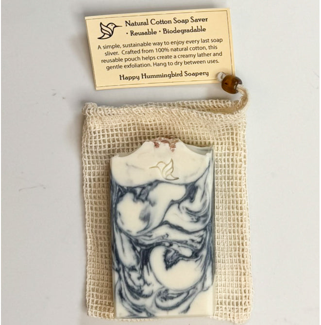 Natural cotton soap saver pouch with coffee-colored wooden bead drawstring, shown with Happy Hummingbird Soapery Ocean Drift artisan soap bar & instruction card.