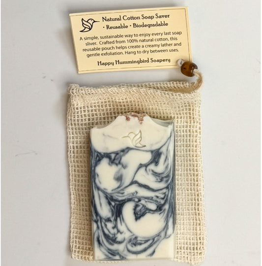 Natural cotton soap saver pouch with coffee-colored wooden bead drawstring, shown with Happy Hummingbird Soapery Ocean Drift artisan soap bar & instruction card.