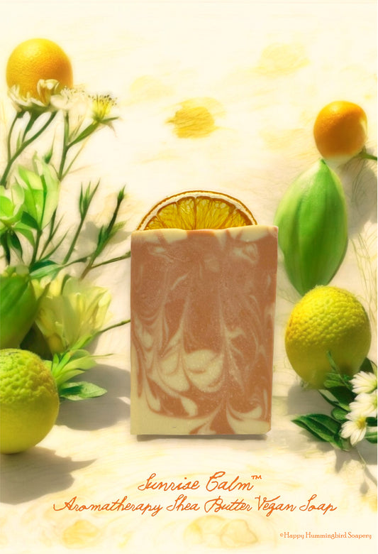 Sunrise Calm orange and bergamot aromatherapy soap with shea butter, pictured on a watercolor citrus botanical background.