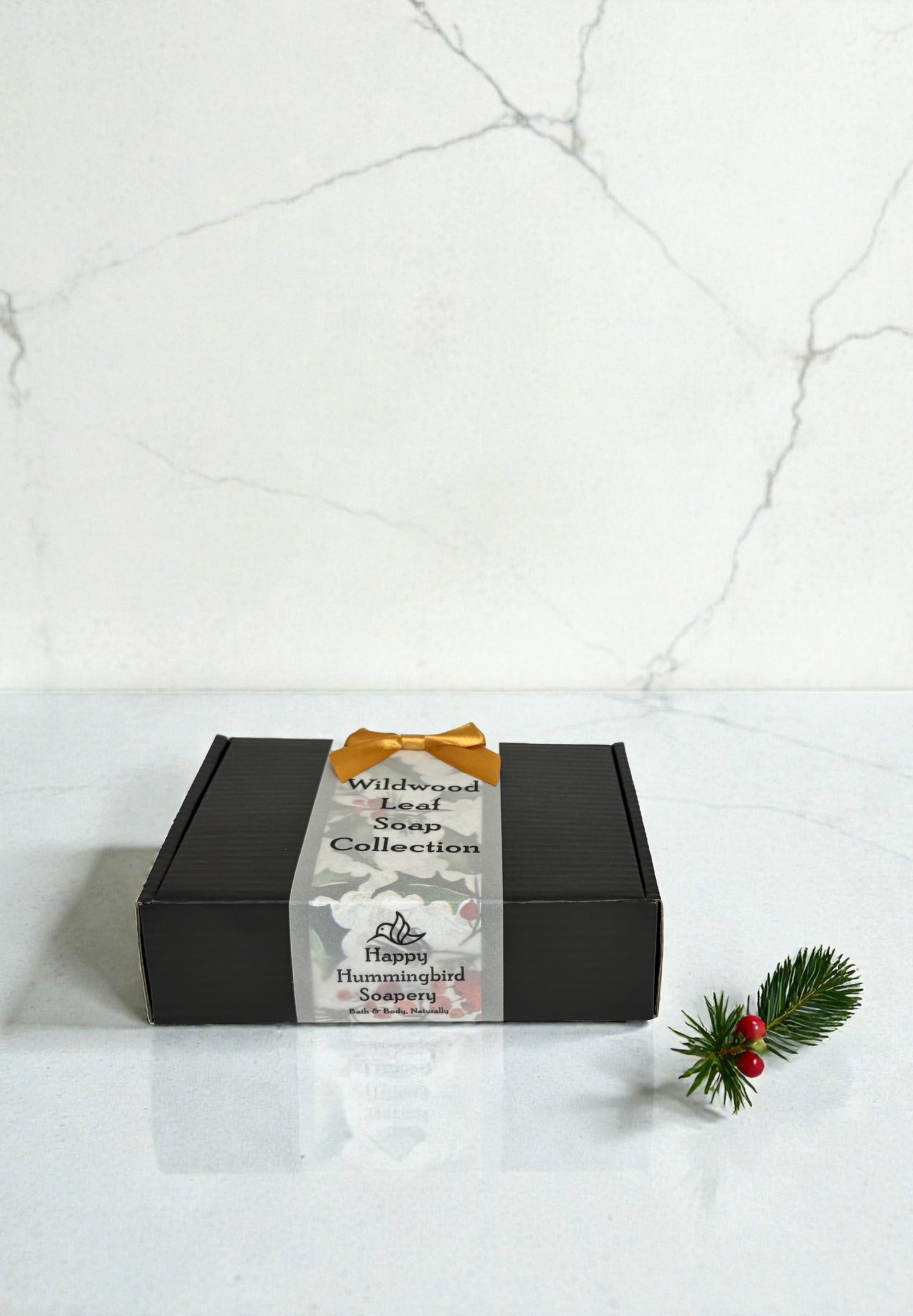 Wildwood Leaf Soap Gift Set closed gift box with gold bow on marble background.