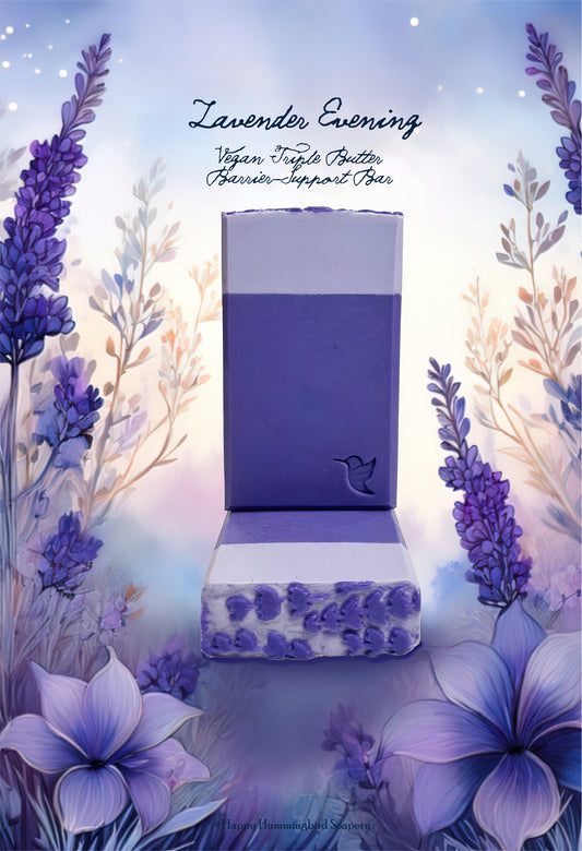 Handcrafted Lavender Evening Ritual vegan soap bar by Happy Hummingbird Soapery, featuring dual-toned purple layers and a signature hummingbird stamp, set against a soft-focus botanical lavender background.
